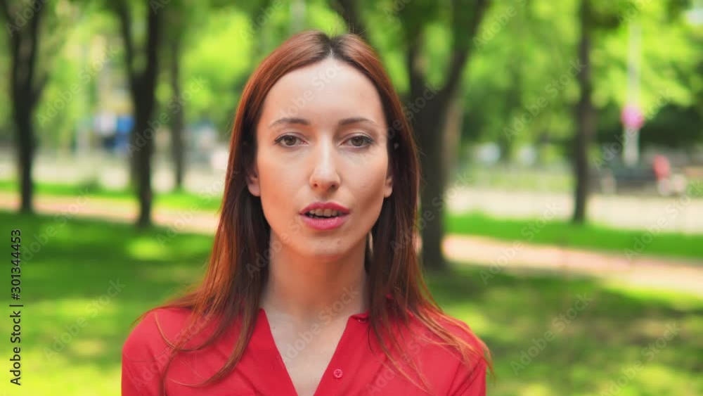 caucasian girl looks at the camera feel wonder cheerful female in red shirt posing outside nature summer background caucasian girl looks at the camera feel wonder cheerful female in red shirt posing outside nature summer background