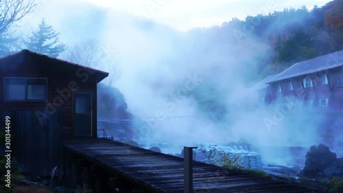 Morning view of Tamagawa Hot Spring or Tamagawa Onsen in autumn season. White steam flow over the area in the Tamagawa onsen in Towada-Hachimatai National Park at Senboku City, Akita Prefecture, Japan photo