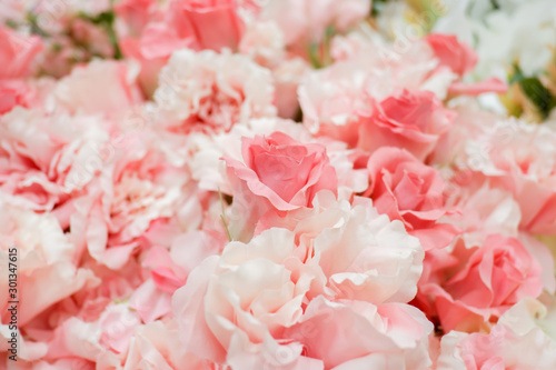 Pastel artificial rose and carnation flowers for background