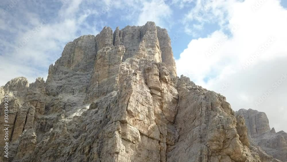 Upward drone shooting in Summer season to the spectacular dolomite rocks in the Lagazuoi mount area, near Passo Falzarego and Cortina D'Ampezzo, Italy. Upward drone shooting in Summer season to the spectacular dolomite rocks in the Lagazuoi mount area, near Passo Falzarego and Cortina D'Ampezzo, Italy.