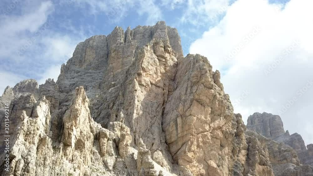 Upward drone shooting in Summer season to the spectacular dolomite pinnacles and rocks in the Lagazuoi mount area, near Passo Falzarego and Cortina D'Ampezzo, Italy. Upward drone shooting in Summer season to the spectacular dolomite pinnacles and rocks in the Lagazuoi mount area, near Passo Falzarego and Cortina D'Ampezzo, Italy.