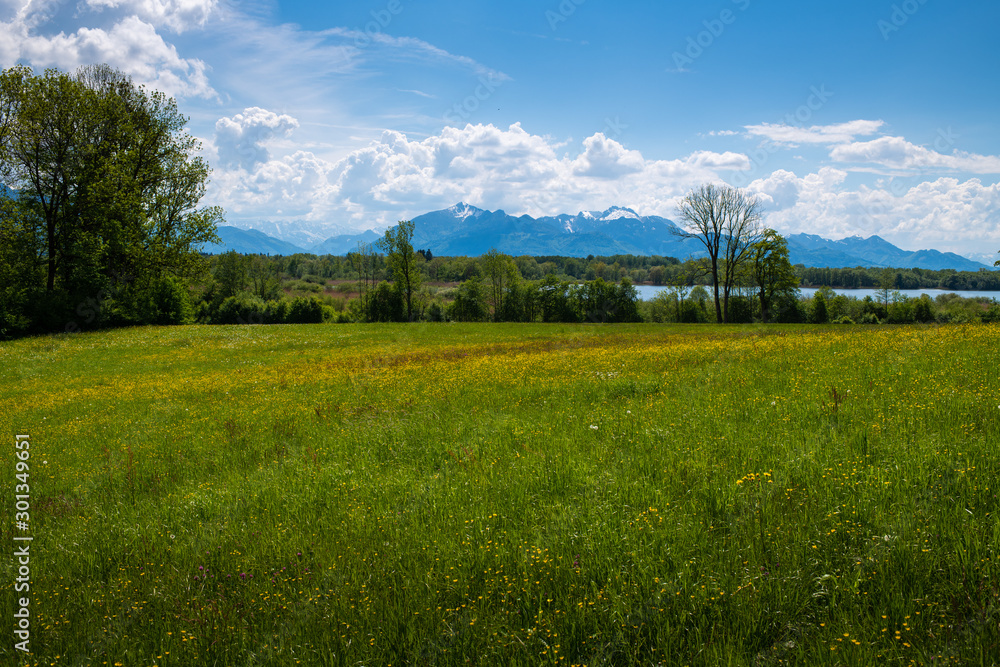 The sky and landscape in Bavaria, closed to the mountains the alps with beatufil clouds, fields and lakes  