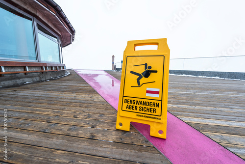 Warning about slippery sign in Swiss alps photo