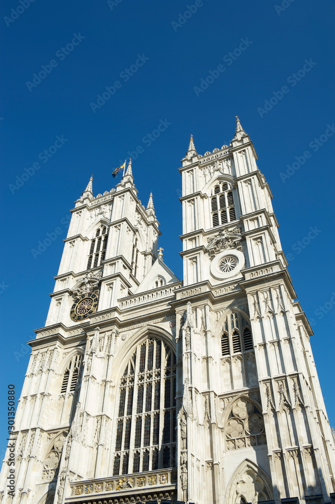Fototapeta premium Bright sunny exterior view of Westminster Abbey under blue sky in London, UK