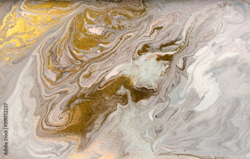 Marble pattern with golden glitter. Abstract liquid background.