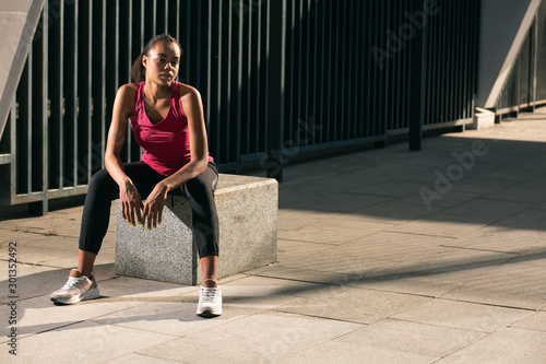 Thoughtful calm athlete outdoors alone stock photo