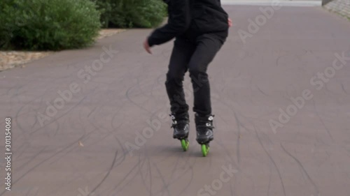 Inline Skater jumps to skate backwards photo