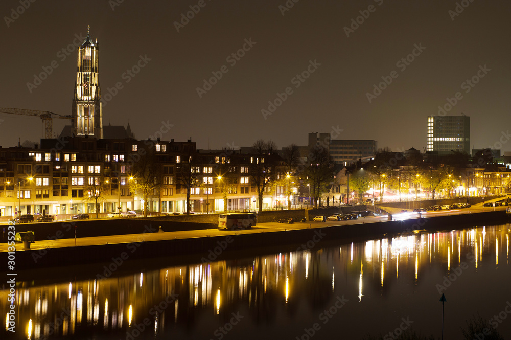 Arnhem in the Netherlands, with St. Eusebius church at night with in the foreground the river Rhine