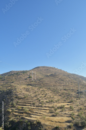 Mountain with agricultural terraces or bancales handmade in the south of Spain photo