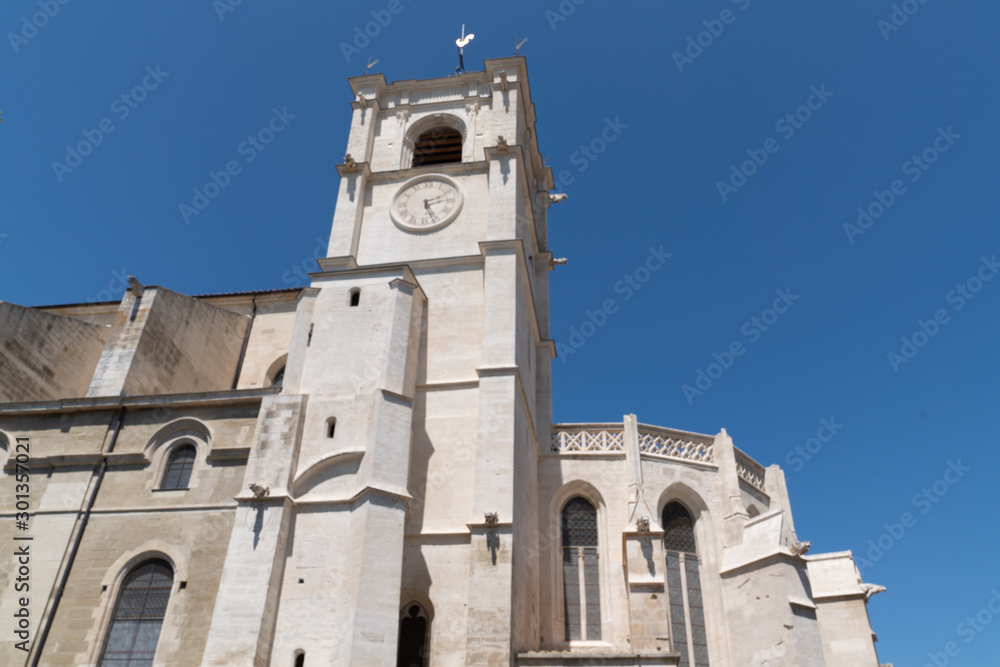 L'Isle-sur-la-Sorgue city view of the facade and clock tower of the main catholic church Notre Dame des Anges france