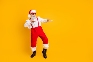 Full size photo of funny crazy cool santa claus fairy hipster clubber enjoy x-mas christmas time party dance wear stylish shirt suspenders trousers isolated over yellow color background