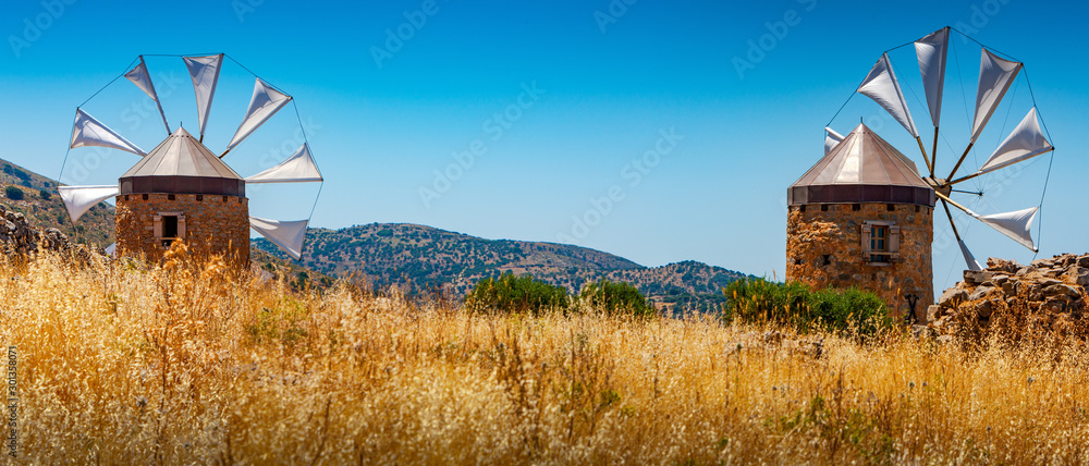 Old windmills on the island of Crete, Greece. - obrazy, fototapety, plakaty 