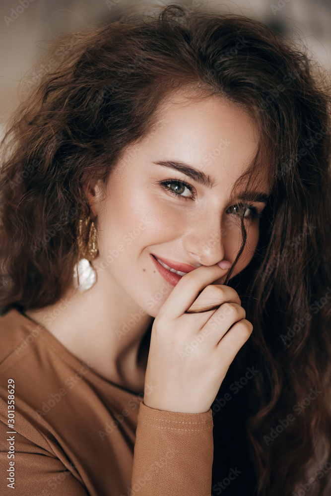 Portrait of beautiful girl with makeup in fashion brown clothes Portrait of beautiful girl with makeup in fashion brown clothes