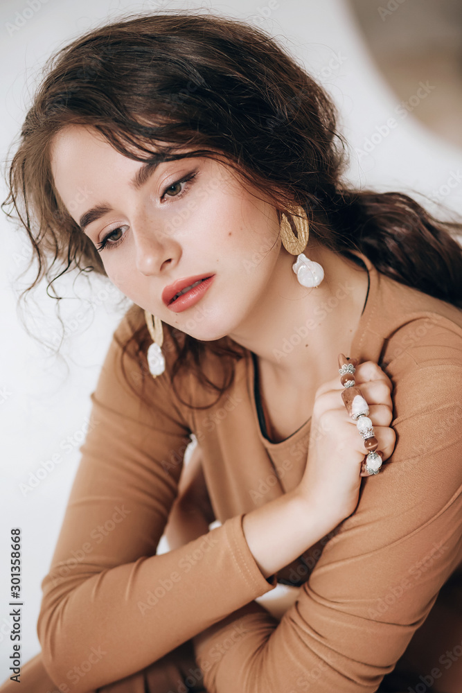 Portrait of beautiful girl with makeup in fashion brown clothes