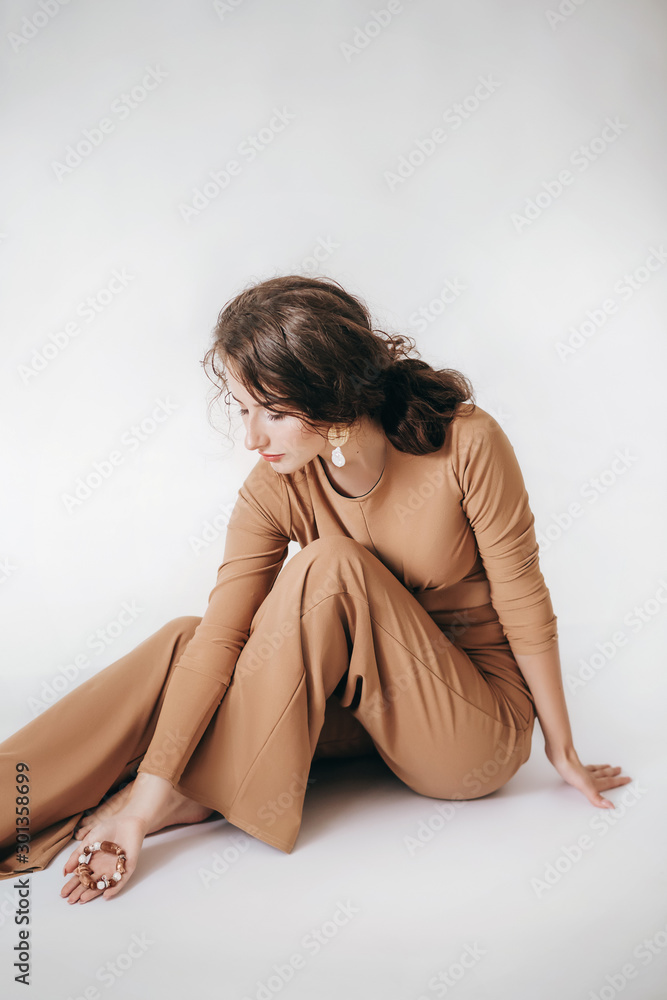 Portrait of beautiful girl with makeup in fashion brown clothes Portrait of beautiful girl with makeup in fashion brown clothes