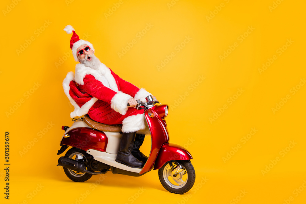 Full body photo of santa grandpa riding 