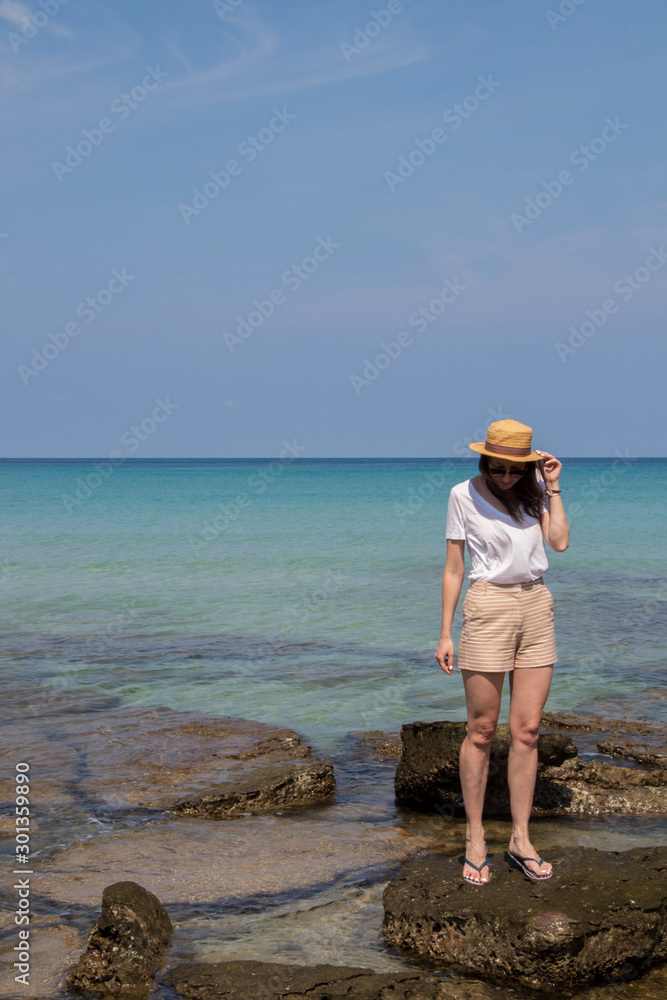 Young woman on the shore of a beautiful bay in Thailand, Koh Kood island