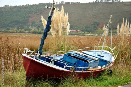 Boat stranded in the port of Bustio in Asturias photo