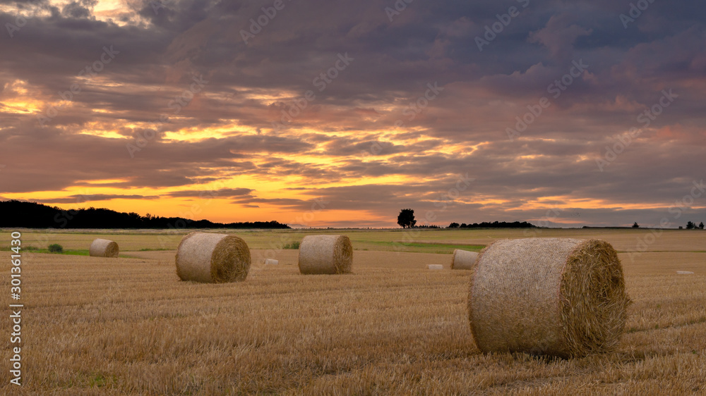 bales of hay, clouds and sunset