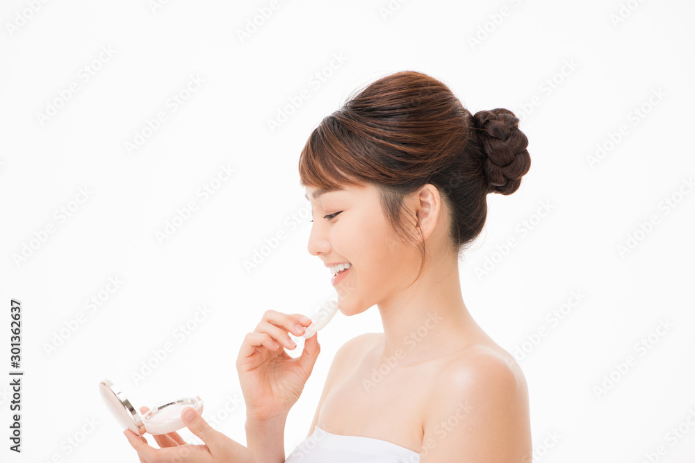 Portrait of beautiful asian woman applying powder puff at cheek makeup of cosmetic, Portrait of beautiful asian woman applying powder puff at cheek makeup of cosmetic,