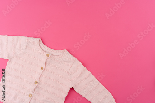  baby clothes on pink background top view