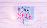Word writing text Home Office. Business photo showcasing space designated in a demonstrating s is residence for official business Green clothespin white wood background colored paper reminder office