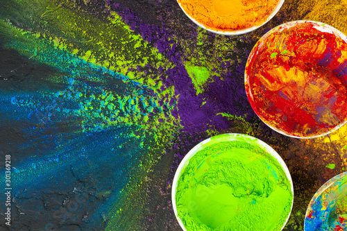 Indian Holi festival colours in small bowls on dark background