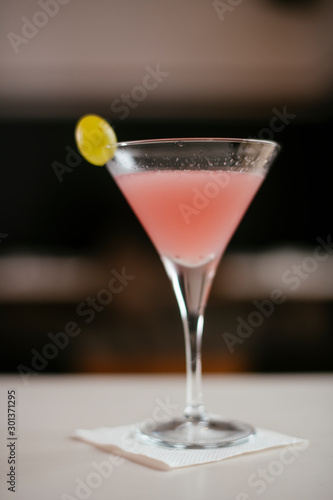 Cosmopolitan cocktail served on bar counter