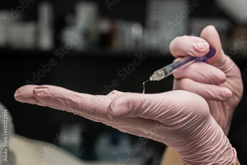 contour plastic. A cosmetologist injects a botulinum toxin to tighten and smooth out wrinkles on the skin of a female face. photo