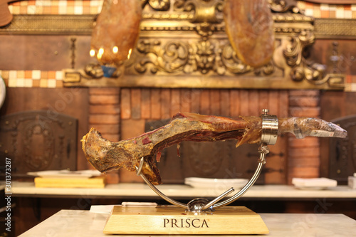 Lisbon, Portugal, November 12, 2019: Beer Museum, located in Terreiro do Paço, Lisbon, Portuguese restaurant. The photo is a steel bracket with salted and cured pork shank called parma ham