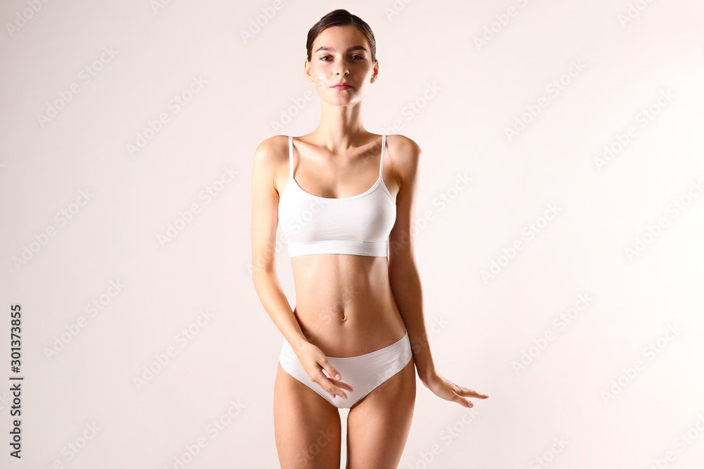 Young woman with fit body in lingerie fashion photoshoot. Body shape concept.