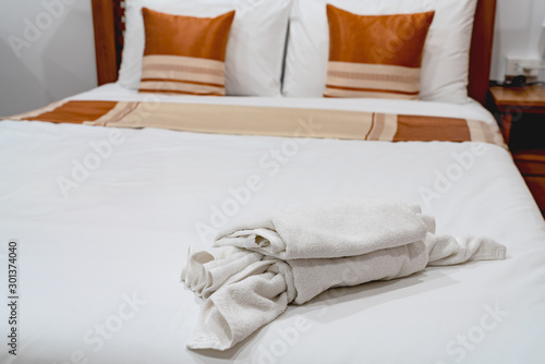 White towel on a wooden bed