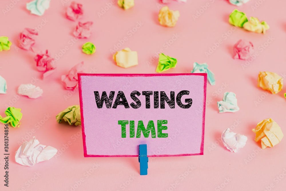 Writing note showing Wasting Time. Business concept for act of spending time doing something that is unnecessary Colored crumpled papers empty reminder pink floor background clothespin Writing note showing Wasting Time. Business concept for act of spending time doing something that is unnecessary Colored crumpled papers empty reminder pink floor background clothespin