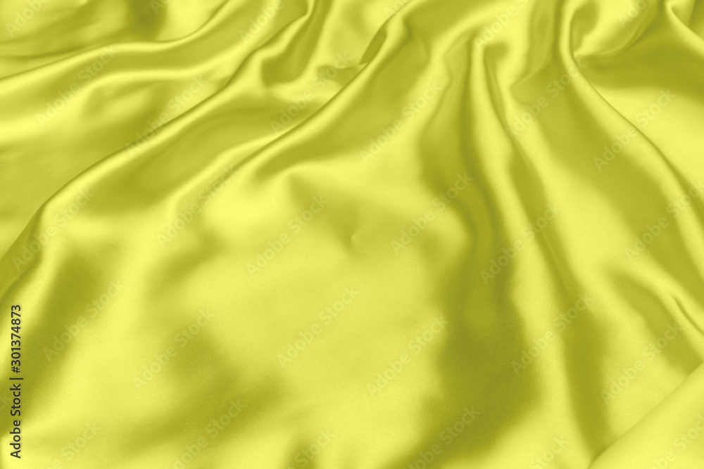 Fototapeta premium Yellow satin fabric texture soft background