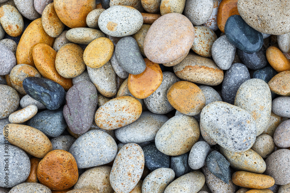 Smooth pebbles at beach, closeup top view. Abstract natural texture background Smooth pebbles at beach, closeup top view. Abstract natural texture background