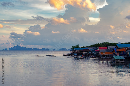 Small village in sea with sunset sky and limestone islands