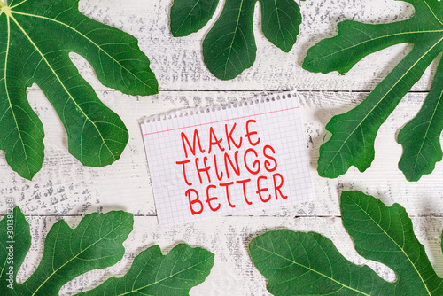 Word writing text Make Things Better. Business photo showcasing Do something to Improve oneself Be the Change Act Leaves surrounding notepaper above a classic wooden table as the background photo