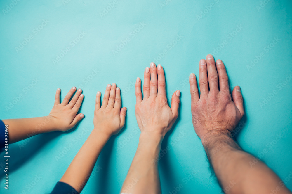 family hands on blue background