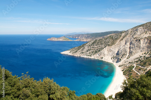 Bright scenic landscape view of Mediterranean Sea lapping at the white stone shore at Myrtos Beach, Kefalonia, Greece