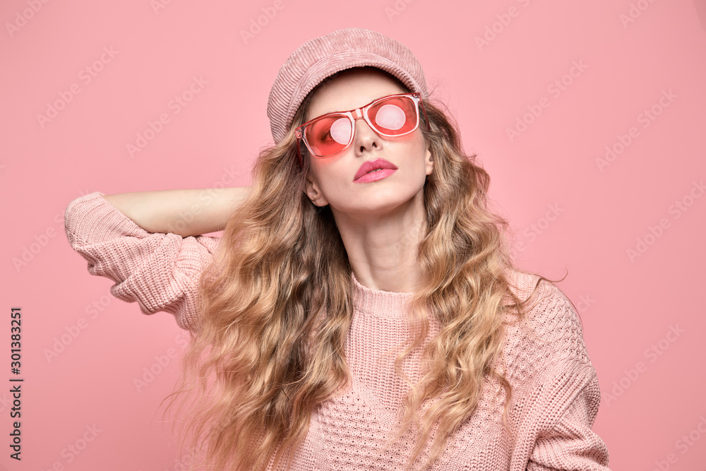 Fashion. Beautiful woman in pink jumper, trendy hairstyle, make up. Adorable blonde girl on pink. Gorgeous fashionable young lady in stylish sunglasses, wavy hair, makeup. Creative beauty pastel shot Fashion. Beautiful woman in pink jumper, trendy hairstyle, make up. Adorable blonde girl on pink. Gorgeous fashionable young lady in stylish sunglasses, wavy hair, makeup. Creative beauty pastel shot