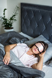 good morning concept - beautiful woman sleeping with mask on her eyes