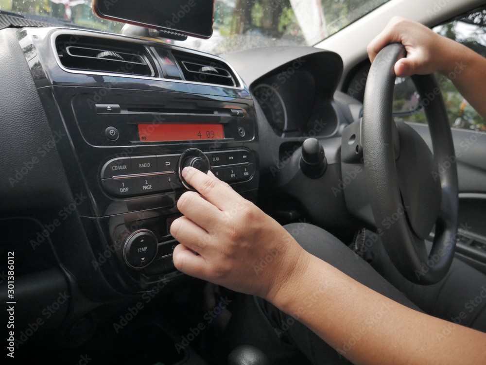 Driver's Hand Press Button on Car Radio