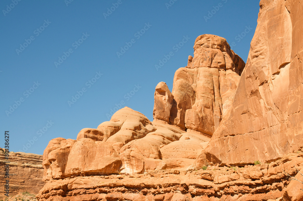 Red sandstone rock mountain standing in bright Southwest sun against blue sky Red sandstone rock mountain standing in bright Southwest sun against blue sky