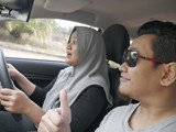 Muslim Woman Learning to Drive with Instructor