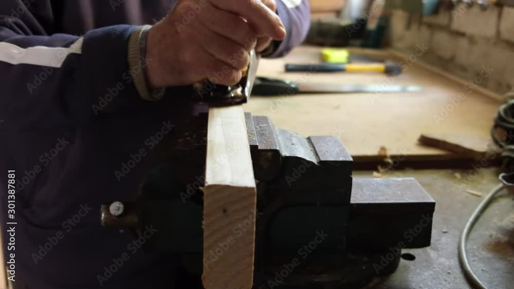Woodworker hand planing in slow motion closeup Woodworker hand planing in slow motion closeup