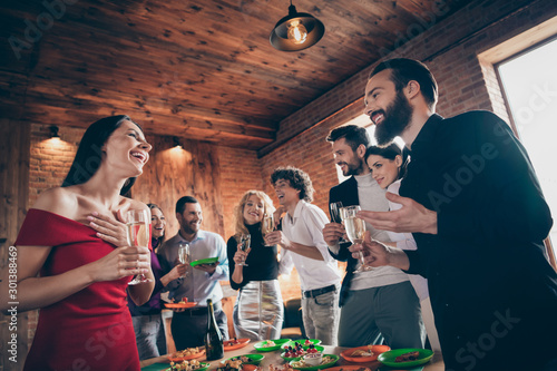 Portrait of nice attractive charming lovely cheerful cheery glad guys meeting corporate event enjoying festal day tradition together talking at modern industrial brick wood loft style interior house