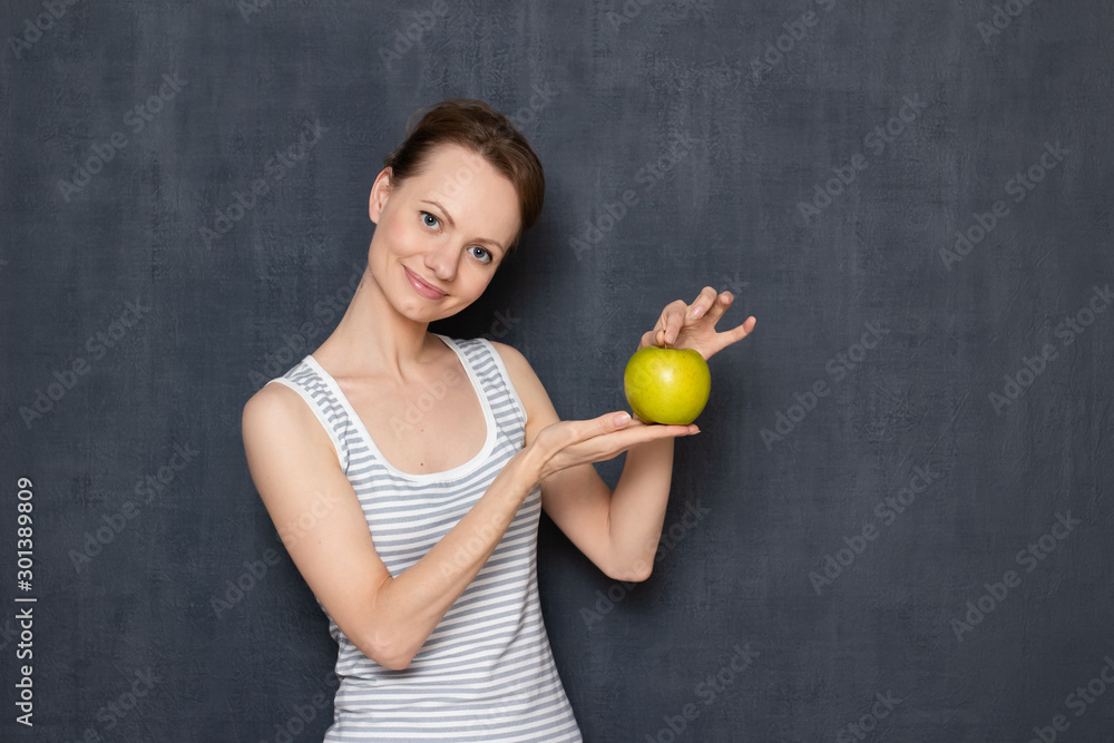 Portrait of happy pretty girl holding ripe apple in hands Portrait of happy pretty girl holding ripe apple in hands