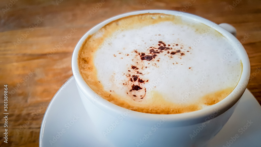 Blurred images of ready-to-drink cappuccino cups placed on a wooden table in the morning as background images and beautiful illustrations Blurred images of ready-to-drink cappuccino cups placed on a wooden table in the morning as background images and beautiful illustrations