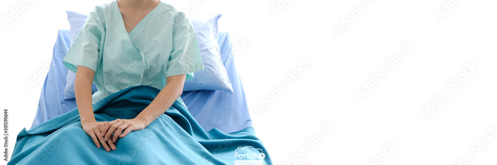 Fototapeta premium female Asian patient looking at camera on her bed in patient's room at hospital panoramic banner with copy space.healthcare and people concept.