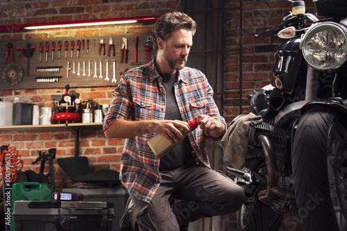 Mechanic or collector servicing a vintage bike